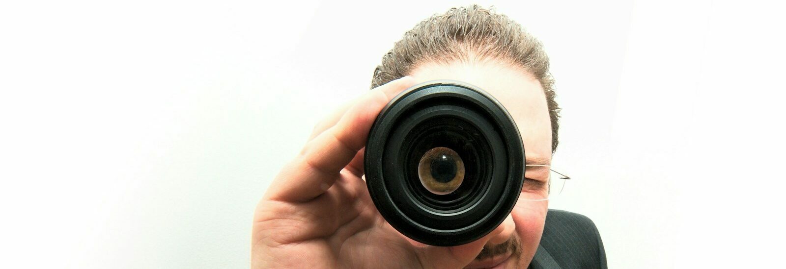 man peeping through monocular