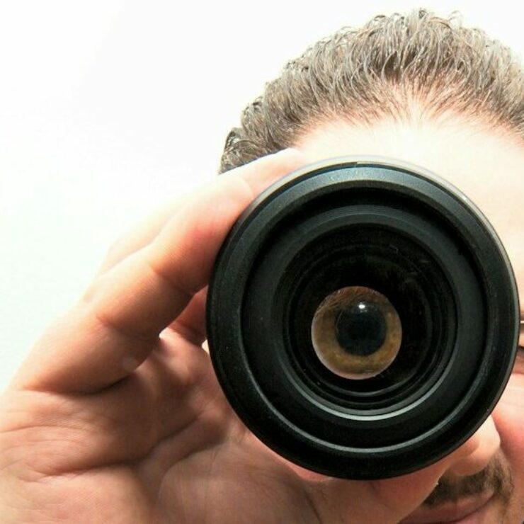 man peeping through monocular