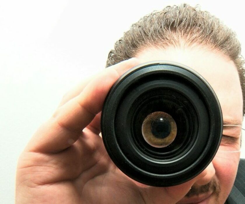 man peeping through monocular